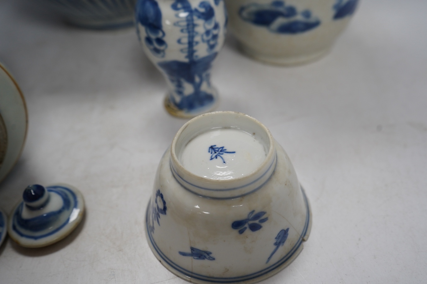 Four Chinese blue and white vases, a jar and cover and a tea bowl, Kangxi to 20th century, tallest vase 38cm high. Condition - poor